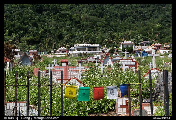 Prayer flags and graves on hillside, Chongde. Taiwan (color)