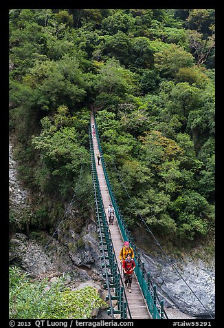 Hikers cross suspension bridge. Taroko National Park, Taiwan (color)