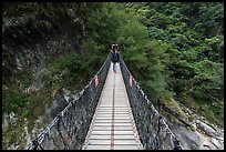 Hiker on suspension footbridge, Taroko Gorge. Taroko National Park, Taiwan (color)