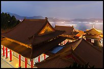 Wen Wu temple at night with light trails from boats. Sun Moon Lake, Taiwan (color)