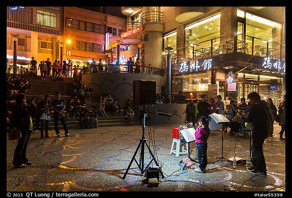 Tourists watch girl singing at night near the pier, Shueishe Village. Sun Moon Lake, Taiwan (color)