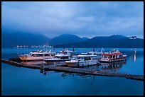 Pier with distant lights of Itashao Village and Syuanzang Temple at dawn. Sun Moon Lake, Taiwan ( color)