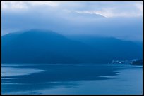 Itashao Village and cloud-shrounded mountains at dawn. Sun Moon Lake, Taiwan (color)