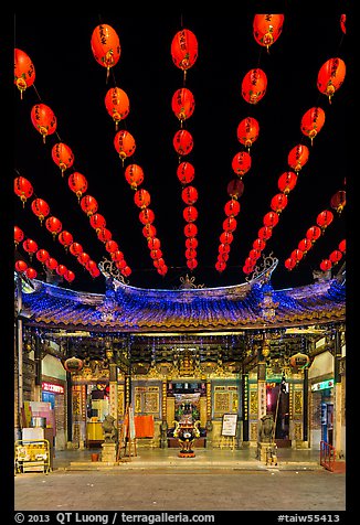 Array of red paper lanterns and temple at night. Lukang, Taiwan