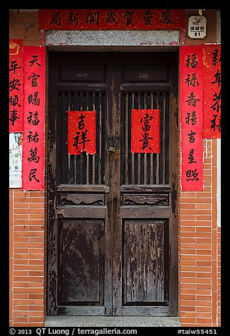 Wooden door with chinese writing on red paper. Lukang, Taiwan