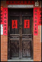 Wooden door with chinese writing on red paper. Lukang, Taiwan (color)