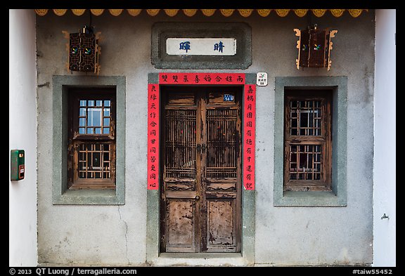 Facade of concrete building with wooden doors and windows. Lukang, Taiwan (color)