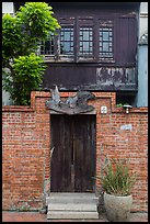 Brick wall and historic wooden house. Lukang, Taiwan (color)