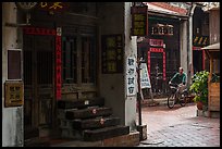 Man on bicycle amidst old houses in alley. Lukang, Taiwan (color)