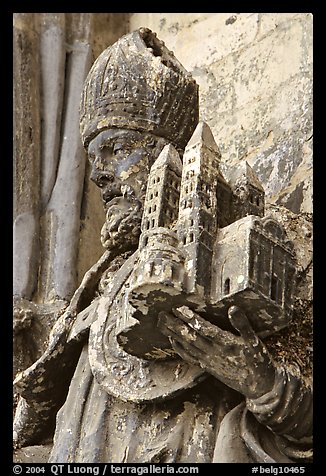 Statue outside of Notre Dame Cathedral showing a model of the cathedral being held. Tournai, Belgium (color)