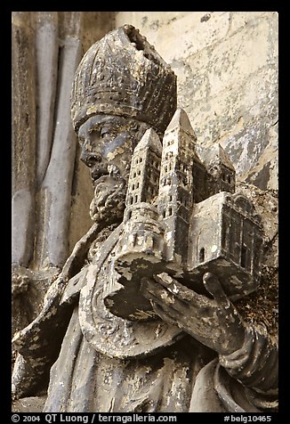 Statue outside of Notre Dame Cathedral showing a model of the cathedral being held. Tournai, Belgium