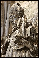 Statue outside of Notre Dame Cathedral showing a model of the cathedral being held. Tournai, Belgium (color)