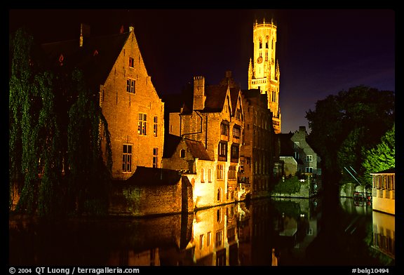 Old houses and beffroi reflected in canal at night. Bruges, Belgium