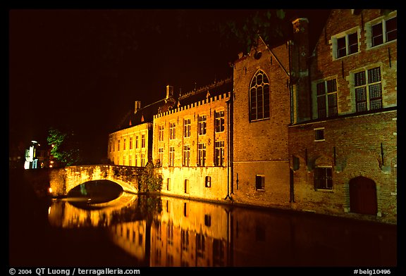 Bridge and houses reflected in canal at night. Bruges, Belgium (color)