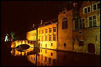 Bridge and houses reflected in canal at night. Bruges, Belgium (color)