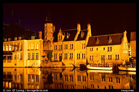 Houses reflected in canal, Rozenhoedkaai, night. Bruges, Belgium