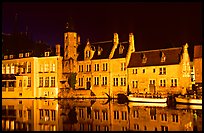 Houses reflected in canal, Rozenhoedkaai, night. Bruges, Belgium