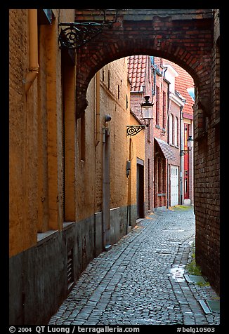 Narrow cobled street and archway. Bruges, Belgium