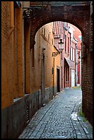 Narrow cobled street and archway. Bruges, Belgium