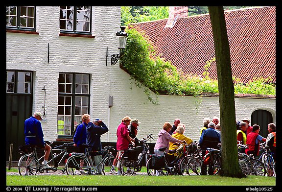 Bicylists in Courtyard of the Begijnhof. Bruges, Belgium