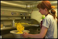 Woman cooking fries in a booth. Bruges, Belgium