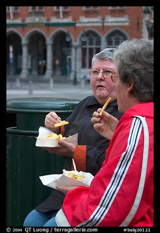 Elderly women eating fries. Bruges, Belgium (color)