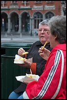 Elderly women eating fries. Bruges, Belgium