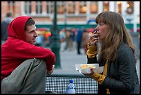 Young woman eating fries, Markt. Bruges, Belgium (color)
