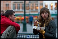 Young woman eating fries, Markt. Bruges, Belgium ( color)