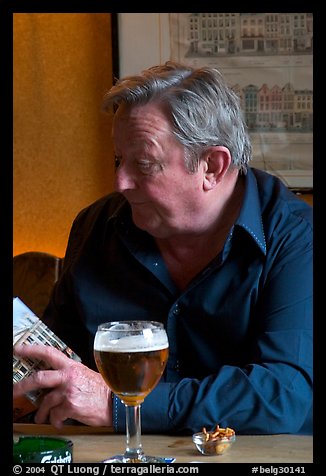 Man with book and beer. Brussels, Belgium