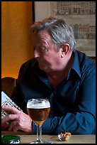 Man with book and beer. Brussels, Belgium ( color)