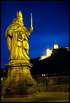 Saint Killian statue on  Alte Mainbrucke (bridge) and Festung Marienberg (citadel) at night. Wurzburg, Bavaria, Germany