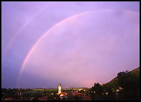 Rainbow over Nesselwang and St Andreas church. Bavaria, Germany (color)