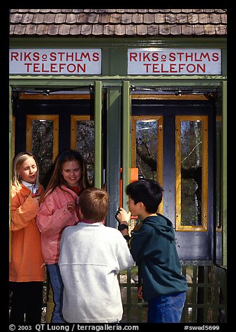 Swedish kids in a phone booth. Stockholm, Sweden