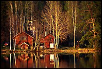 Wooden house reflected in a lake at sunset. Central Sweden (color)