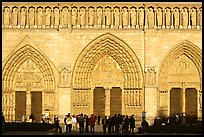 People standing in front of gates of Notre Dame Cathedral, late afternoon. Paris, France ( color)