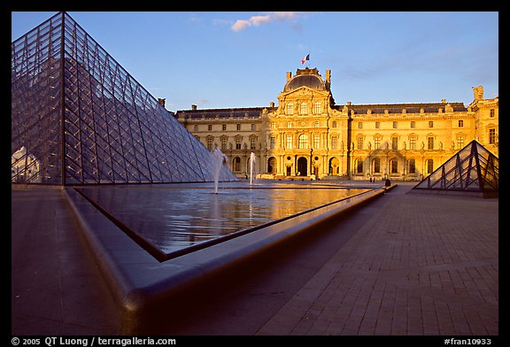 Pyramid, basins, and Sully Wing  in the Louvre, sunset. Paris, France (color)