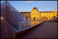 Pyramid, basins, and Sully Wing  in the Louvre, sunset. Paris, France