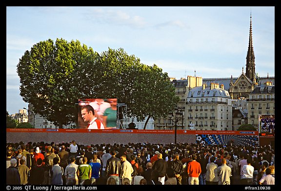 Crowds watch a broadcast of a soccer match near Hotel de Ville. Paris, France (color)