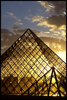 Louvre pyramid transparent at sunset. Paris, France