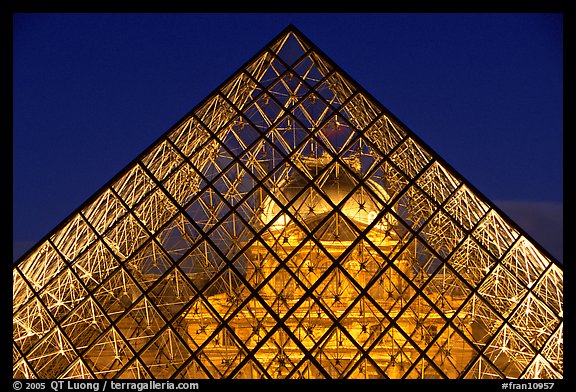 Louvre seen through pyramid at night. Paris, France