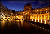 Basin, Pyramid, and Louvre at dusk. Paris, France