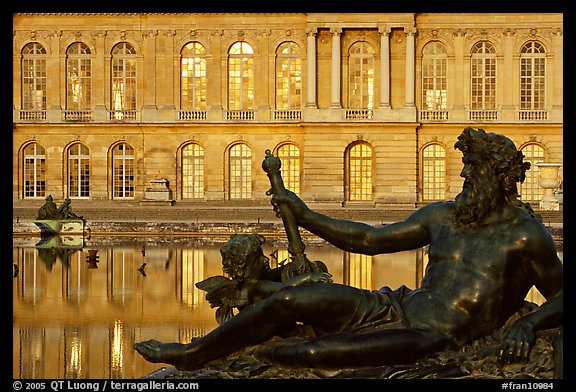 Statue, basin, and facade, late afternoon, Versailles Palace. France