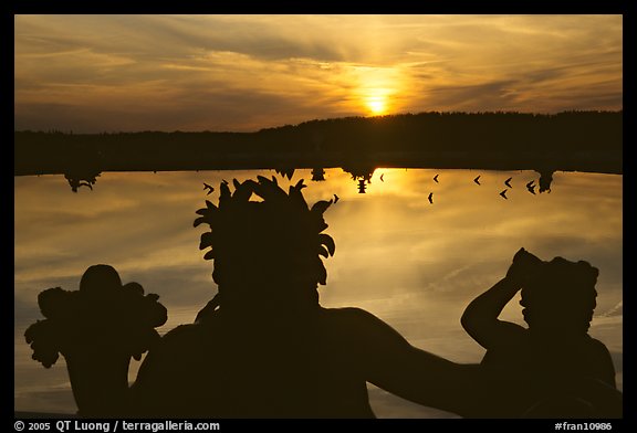 Sunset over a basin in the Versailles palace gardens. France