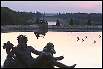 Sculptures, basin, and gardens at dusk, Palais de Versailles. France (color)