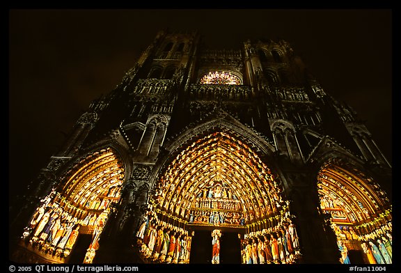 Looking up cathedral with doors laser-illuminated to recreate original colors, Amiens. France