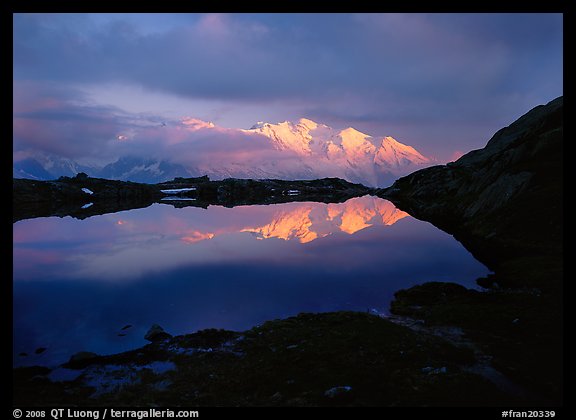 Mont Blanc range reflected in pond at sunset, Chamonix. France