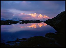 Mont Blanc range reflected in pond at sunset, Chamonix. France