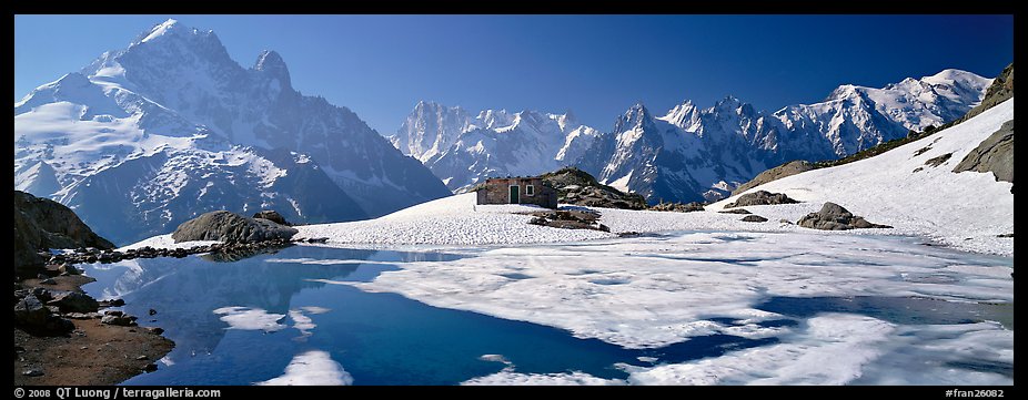 High mountain landscape with partly frozen lake and Mont-Blanc Range. France