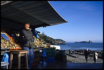 Oyster stand and vendor in Cancale. Cancale oysters are reknown in France. Brittany, France (color)